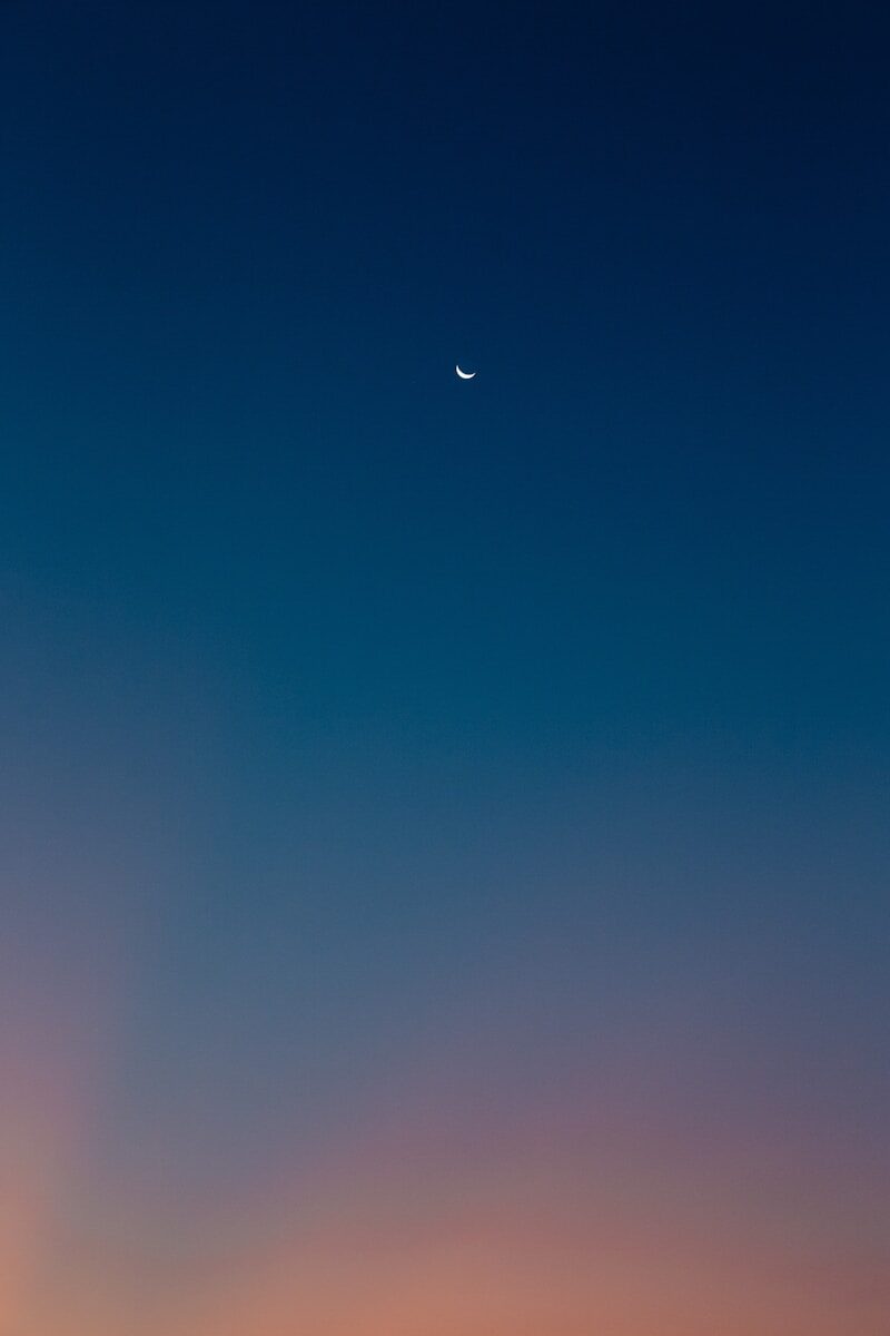 Crescent moon in a gradient twilight sky
